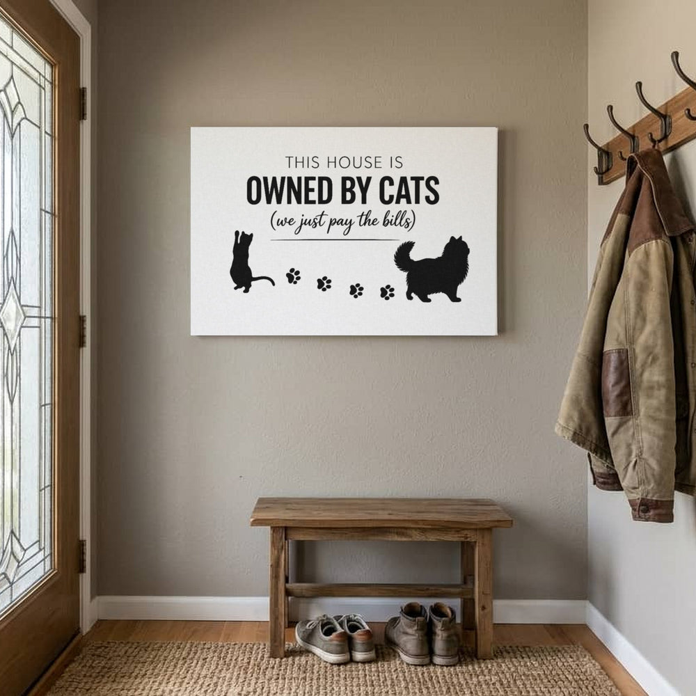 Owned By Cats canvas, White & Black, by the front door above a bench