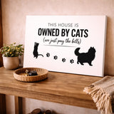 Owned By Cats canvas in White & Black leaning on a wooden console table