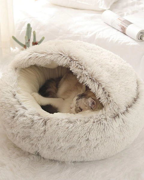 Cat relaxing in the plush fluffy hooded pet bed
