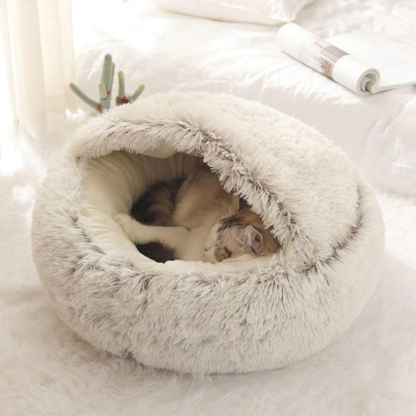 Cat relaxing in the plush fluffy hooded pet bed