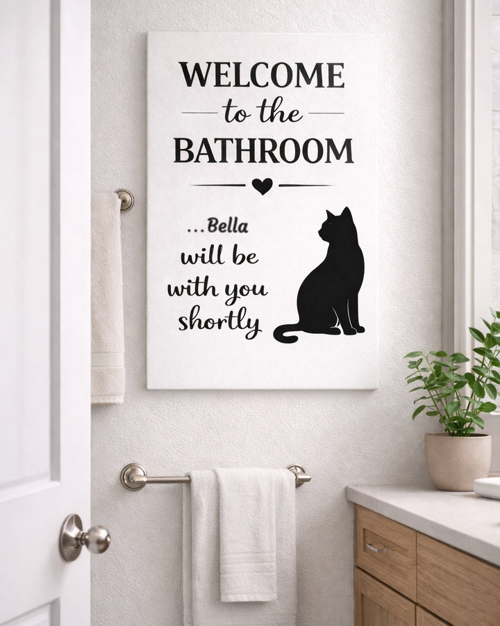 Personalized cat bathroom canvas with the name Bella next to a towel bar