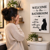 Woman delighted by a personalized cat bathroom canvas gift with the name Coco