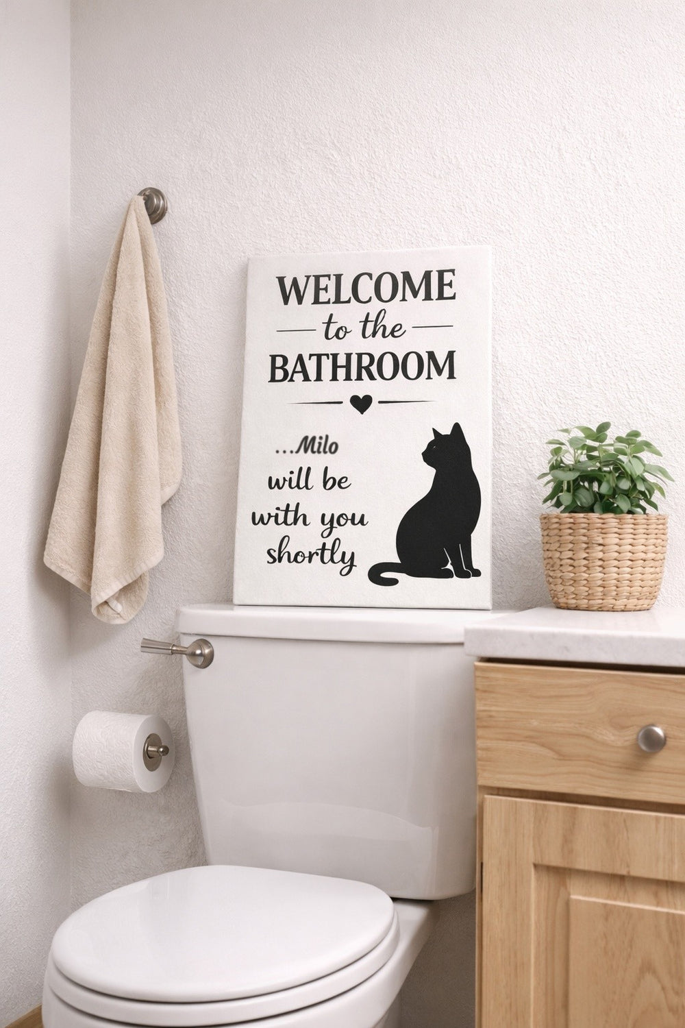 Personalized cat bathroom canvas with the name Milo above a toilet