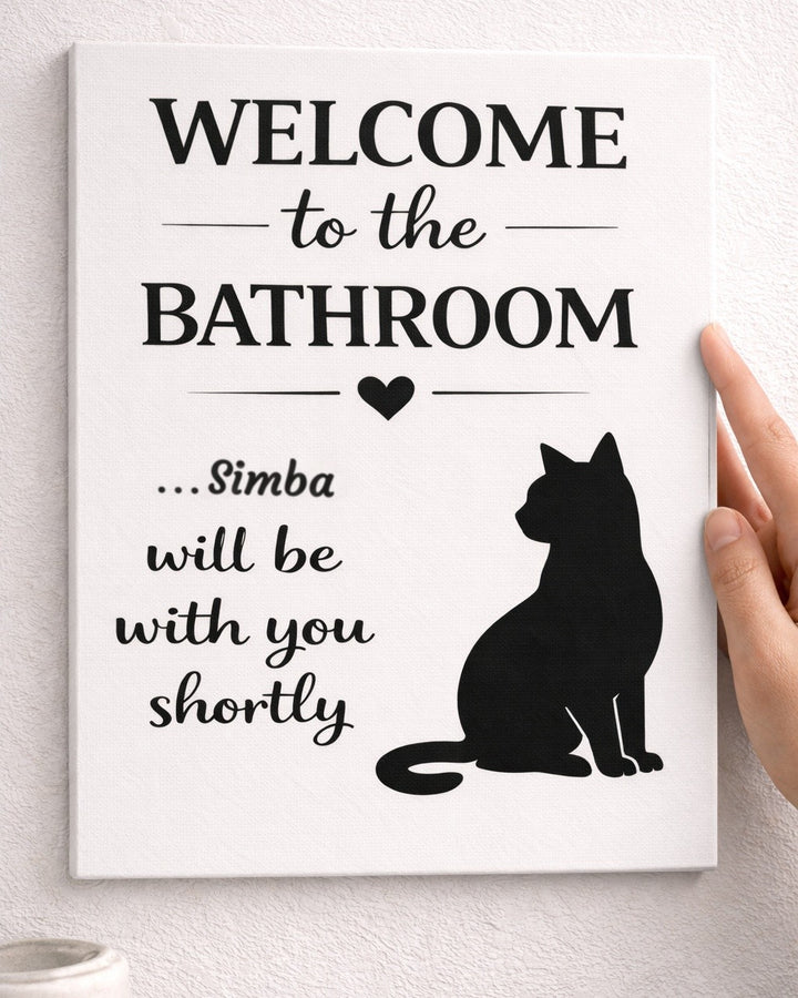 Hand holding a personalized cat bathroom canvas with the name Simba