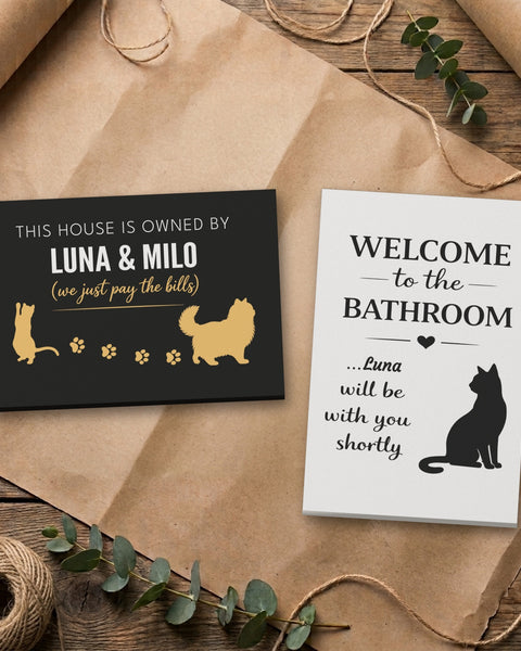 Personalized cat canvas set: Owned By Luna & Milo and Luna bathroom canvas side by side on kraft paper