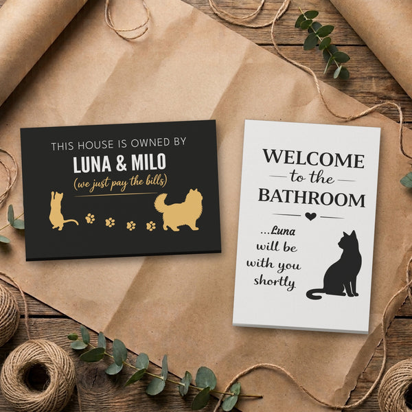 Personalized cat canvas set: Owned By Luna & Milo and Luna bathroom canvas side by side on kraft paper