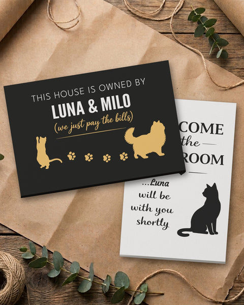 Personalized cat canvas set: Owned By Luna & Milo canvas stacked on the Luna bathroom canvas, on kraft paper