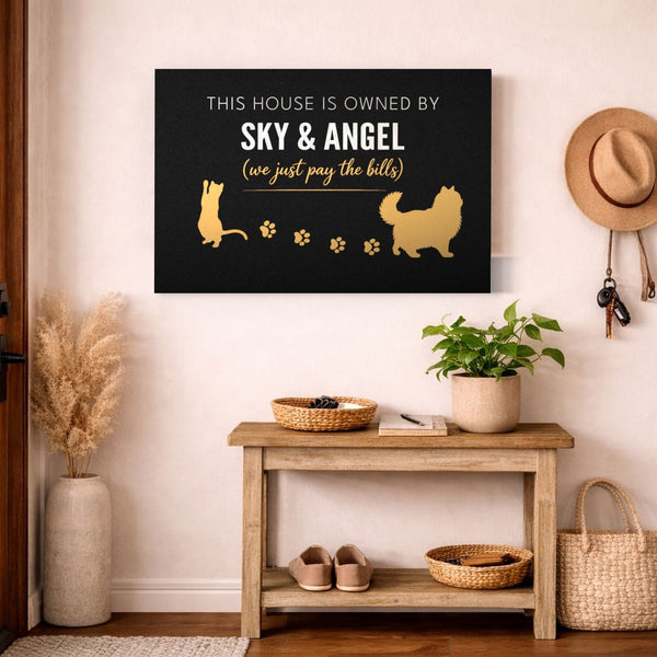 Personalized Owned By Cats canvas, Black & Gold, reading This house is owned by Sky & Angel, above an entryway bench