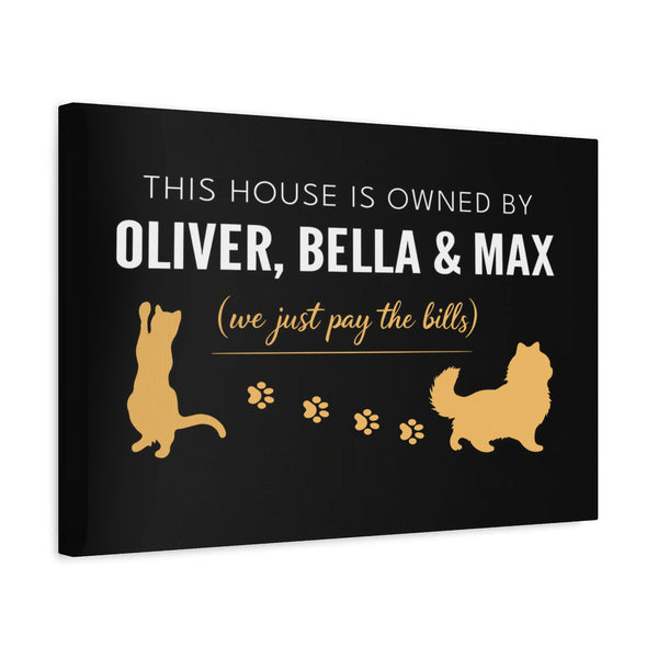 Personalized Owned By Cats canvas, Black & Gold, reading This house is owned by Oliver, Bella & Max, side view showing the gallery-wrapped edge