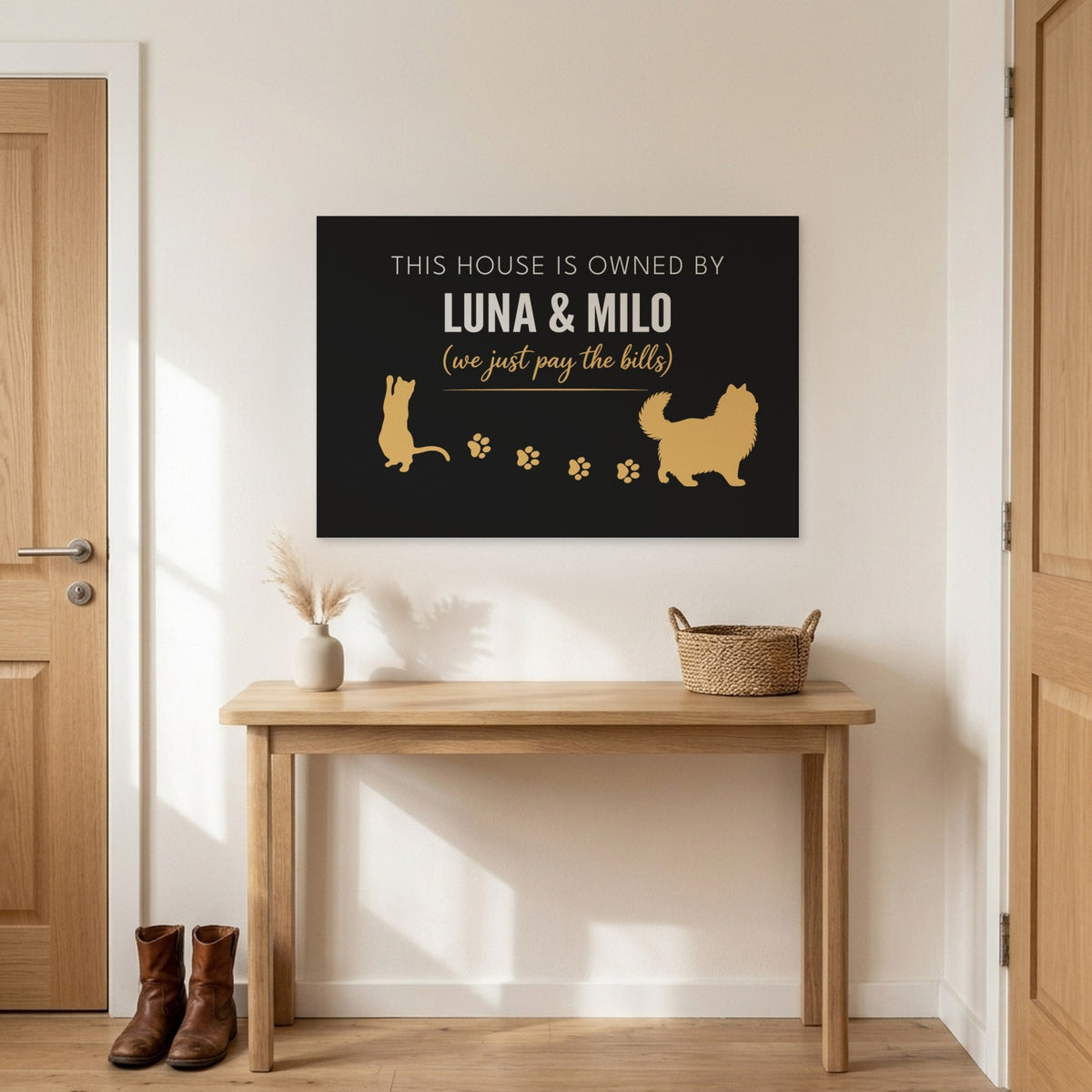 Black and gold This House Is Owned By Luna & Milo canvas above an entryway table