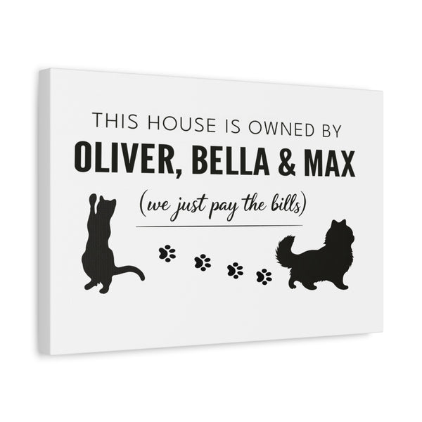 Personalized Owned By Cats canvas, White & Black, reading This house is owned by Oliver, Bella & Max, side view showing the gallery-wrapped edge